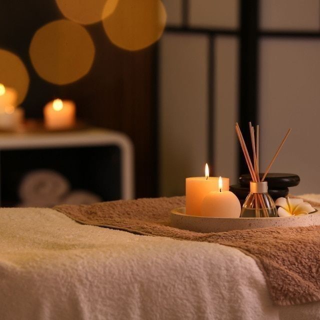 Serene luxury spa treatment room with candles and aromatherapy diffuser at Holistic Luxury Spa & Salon, Arera Colony Bhopal