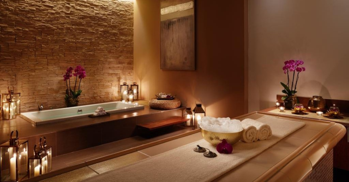 Premium spa suite with jacuzzi bath, massage table, orchid flowers, lanterns and candles at Holistic Luxury Spa & Salon, Bhopal
